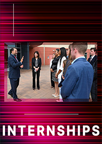 NCIS Interns pictured in front of NCIS headquarters talking with Director Omar Lopez. 